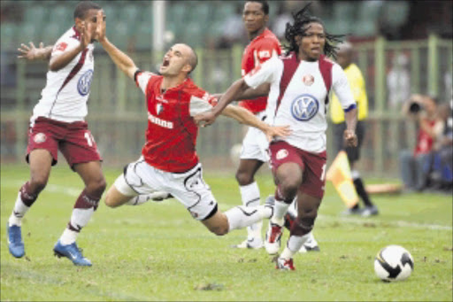 CRASH LANDING: Dillon Sheppard of Platinum Stars going down after being tripped by Cecil Oerson of Swallows while teammate Lefa Tsutsulupa takes off with the ball. Pic: SYDNEY SESHIBEDI. 15/03/2009. © The Times.
