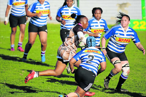 UNDER PRESSURE: Border’s Cindy Booi runs with he ball into a solid wall of Western Province defenders at Buffalo City Stadium. Province won the match 7-5 Picture: ALAN EASON