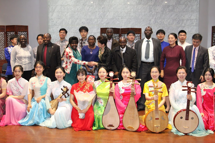 Nanjing University traditional instrument orchestra choir pose for a group photo during the diversity, beauty and harmony traditional Chinese musical instrument performance at the University of Nairobi main campus on April 18, 2024