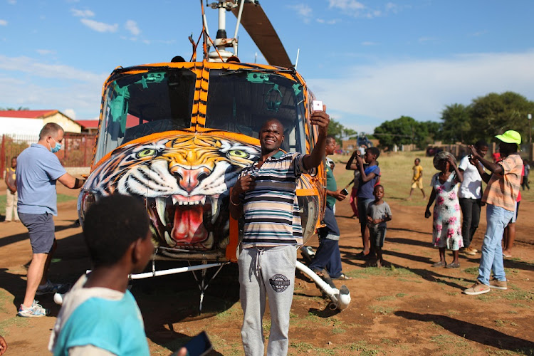 A resident takes a selfie with a helicopter at the Makgwanya daycare centre in Winterveld, north of Soshanguve.