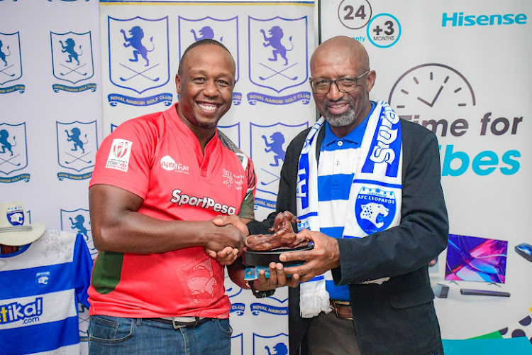 Dr JJ Masiga presents an award to one of the winners during the tournament to celebrate his career in sports