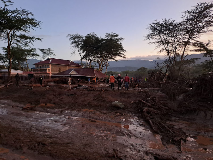 People inspect a house that has been damaged by landslides due to the ongoing heavy rains at Kamuchiri village in Mai Mahiu, Nakuru County on Aril 29. 2024.