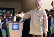 African National Congress (ANC) President Nelson Mandela smiles broadly 27 April 1994 in Oshlange, black township near Durban, as he casts his historic vote during South Africa's first democratic and all-race general elections. File photo