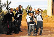 IN THE GROOVE: Schoolchildren cheer Absa Cape Epic riders as they pass through Villiersdorp yesterday
