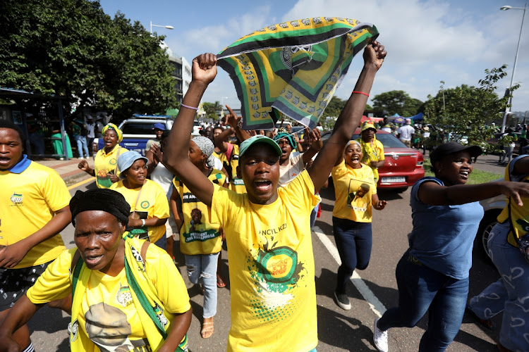 ANC supporters sing outside the high court in Durban during the party's court case against the MK party.