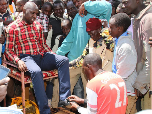Elgeyo Marakwet Senator Kipchumba Murkomen has his shoes shined in Iten town on December 10 / MATHEWS NDANYI