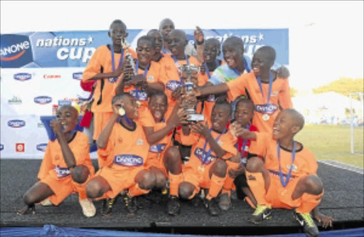 PACK YOUR BAGS: Daniye Primary School celebrates after winning the 2013 Danone Under-12 national finals at WJ Clements Stadium in Reiger Park on Saturday Photo: BackpagePix