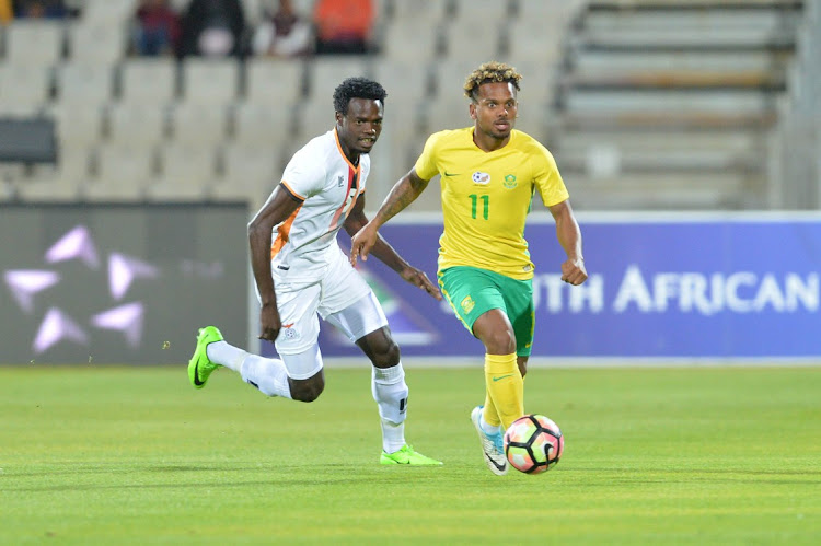 Isaac Samujompa of Zambia and Kermit Erasmus of South Africa during the International friendly match between South Africa and Zambia at Moruleng Stadium on June 13, 2017 Moruleng, South Africa.