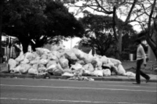 NO SERVICE: Uncollected garbage strewn all over the pavements in Durban. Photo: Thuli Dlamini. 02/10/08. © Sowetan.