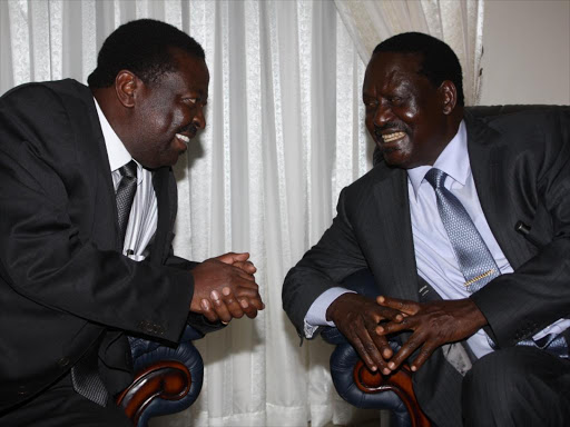 Cord leader Raila Odinga chats with ANC leader Musalia Mudavadi at a past function. PHOTO / FILE