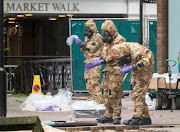 Members of the military work in the Maltings shopping area, close to the bench where Russian former double agent Sergei Skripal and his daughter Yulia were found critically ill seven weeks ago. 