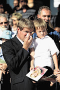 Nico Henning holds his son, Benjamin, at the funeral of his estranged wife, Chanelle Henning, in Hartbeespoort, North West. File photo.