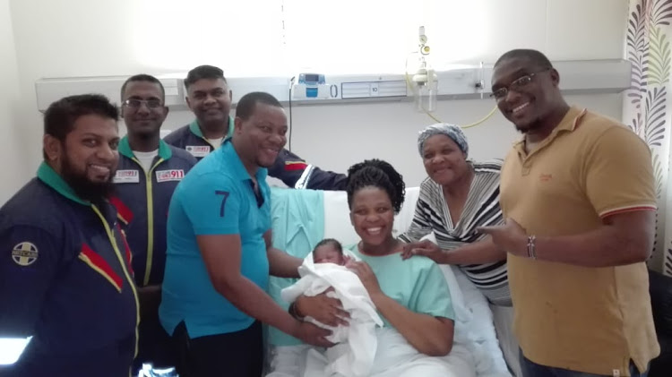 From left: Netcare 911's Akram Kader, Preshan Harrilal and Clive Naidoo, Mr Philani Bhengu (father), Mrs Nontuthzelo Bhengu (mother), Baby Sibusisiwe Bhengu, Mrs Bhengu (grandmother), Dr D Ngotho Obstetrician and gynaecologist.