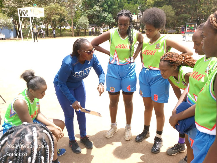 Jkuat coach Mary Chepkoi (2nd L) issues instructions during a break