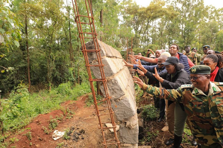 Environment: CS Soipan Tuya helps to bring down a perimeter wall erected at Ololua forest. Image: Handout.