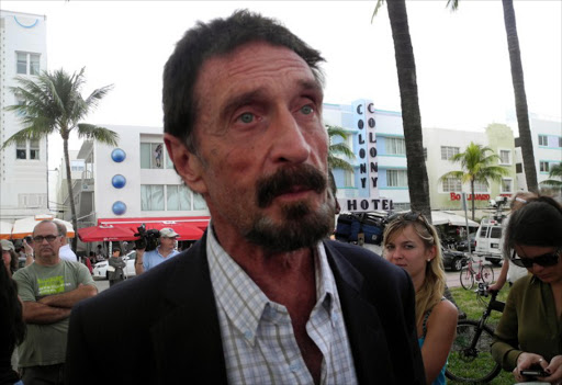 Software company founder John McAfee(C) talks to AFP. File photo.