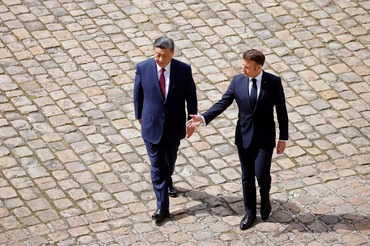 French President Emmanuel Macron, right, and China's President Xi Jinping attend an official welcome ceremony in the courtyard of the Hotel national des Invalides in Paris, France. Picture: JOHANNA GERON/REUTERS