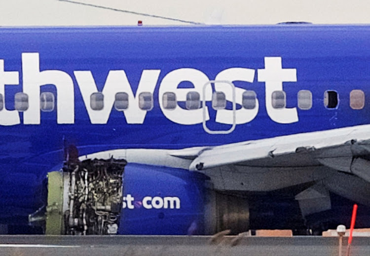 Emergency personnel monitor the damaged engine of Southwest Airlines Flight 1380, which diverted to the Philadelphia International Airport after the airline crew reported damage to one of the aircraft's engines, on a runway in Philadelphia, Pennsylvania US on April 17, 2018.