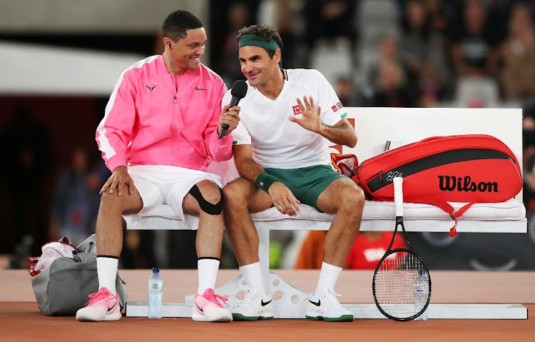 Trevor Noah interviews Roger Federer during a changeover in the Match in Africa against Rafael Nadal at Cape Town Stadium on February 7 2020.