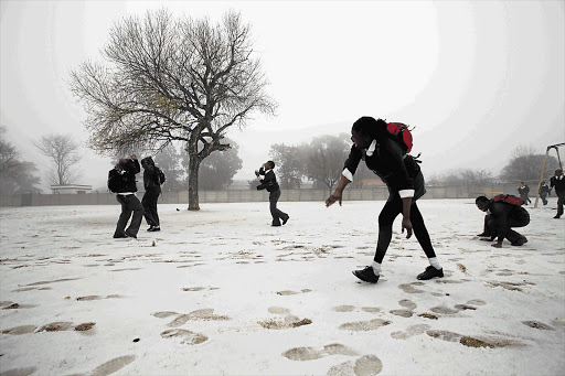 Pupils play with the thick sleet covering Laer Skool Voorbrand school yard in Rosettenville, Johannesburg, yesterday Picture: SYDNEY SESHIBEDI