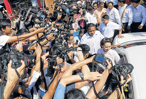 MOMENT TO RELISH: Myanmar opposition leader Aung San Suu Kyi, chairwoman of the National League for Democracy (NLD), leaves NLD headquarters in Yangon, Myanmar after delivering a speech yesterday. She hinted at victory in her first address since election polls closed the day before Picture: EPA