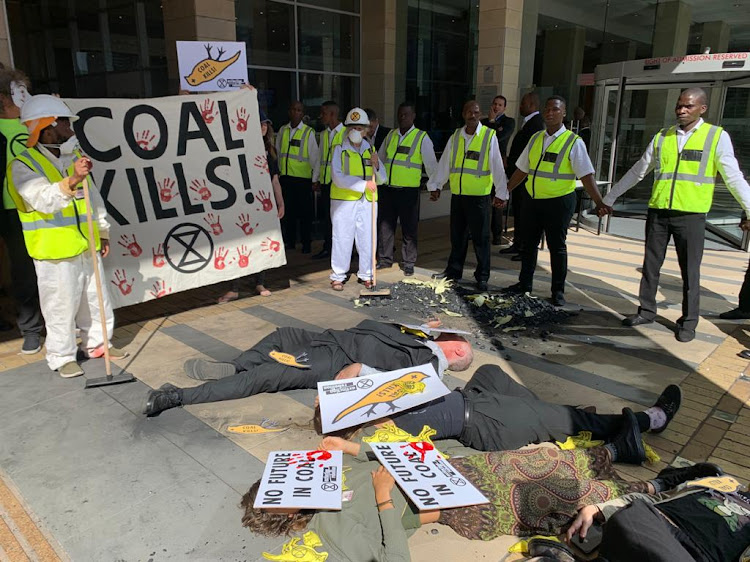 Security guards form a cordon around an Extinction Rebellion protest outside the Southern African Coal Conference in Cape Town on January 30 2020.