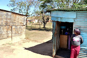 Mandisa Tom, Aqhama’s mother, stares at the shack where her daughter may have been murdered