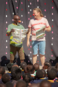 Clowns Sibusiso Dlamini and Gavin Stockden show good library practises during the Nal'ibali and Clowns Without Borders SA library show.