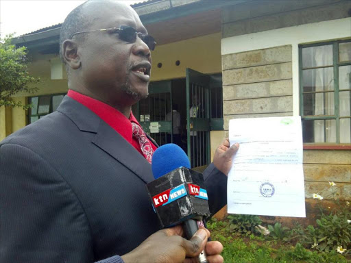 Former IG David Kimaiyo holds his nomination certificate after he was cleared by IEBC to run for the Elgeyo Marakwet Senate seat, May 28, 2017. /STEPHEN RUTTO