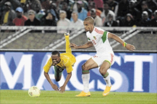 TOUGH ONE: Bafana Bafana's Thulani Serero tumbles under the challenge of Tony Baudr of Congo during their 0-0 drawn Africa Cup of Nations qualifier in Polokwane last night photo: Lefty Shivambu/ Gallo Images