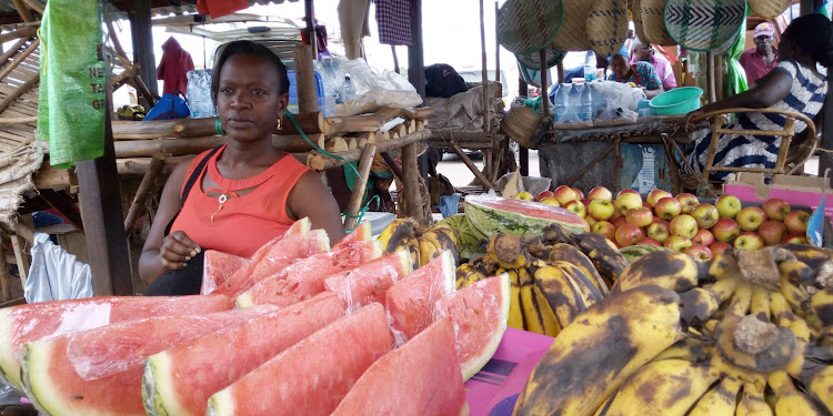 Fruit vendor Jacintah Kalunda sells fruits at Voi town.