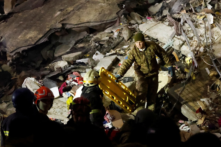 Emergency personnel work at the site where an apartment block was heavily damaged by a Russian missile strike in Dnipro, Ukraine, on January 15 2023.