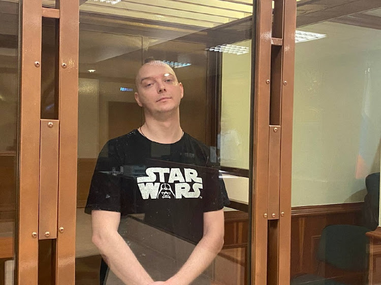 Ivan Safronov, a former journalist and an aide to the head of Russia's space agency Roscosmos, stands inside a defendants' cage in a Moscow court, August 30 2022. Picture: PRESS SERVICE OF MOSCOW CITY COURT/REUTERS