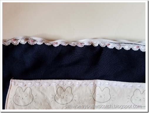 Pinning lace to the case along the zipper. Pinning lace to the case along the zipper.