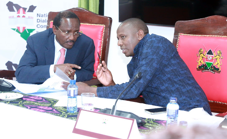 National Dialogue Committee co-chairs Kalonzo Musyoka and Kimani Ichung'wah consult during Monday's public submission of views at the Bomas of Kenya, October 2, 2023.