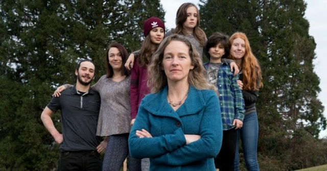 Julia Olson, executive director and chief legal counsel at Our Children's Trust, stands with some of the youth plaintiffs from the landmark lawsuit Juliana v. United States. Photo: Robin Loznak