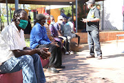 Thiathu Mamafha who had his two room shack demolished waits in line. 