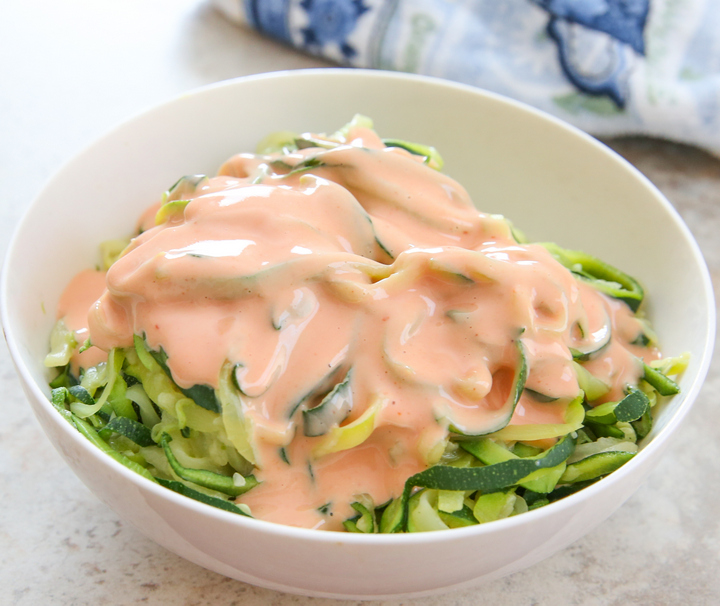 skinny bang bang zucchini noodles in a white bowl