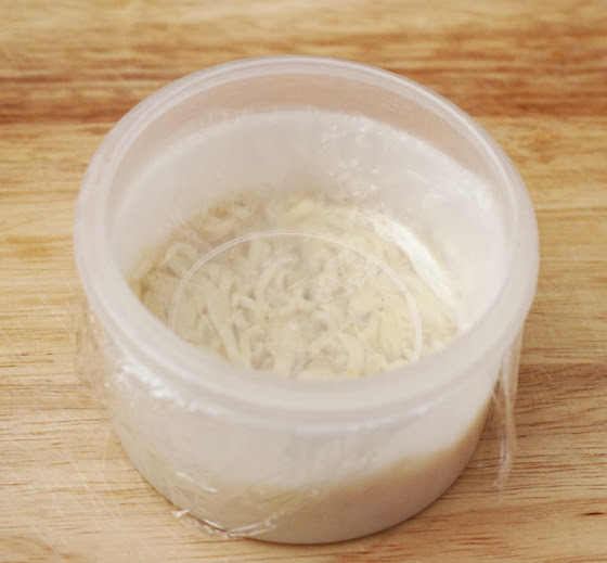 photo of a the ramen in a container pressed down