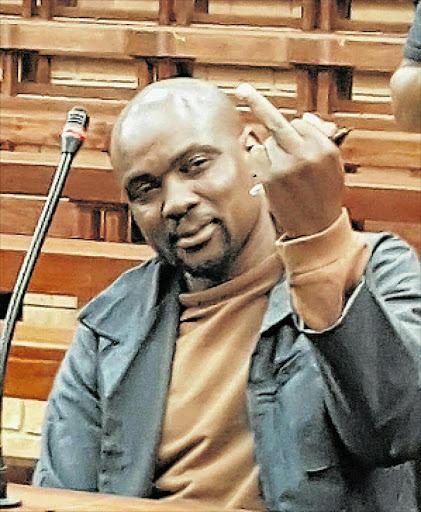 UNREPENTANT: Lonwabo Solontsi gestures at Daily Dispatch journalist Adrienne Carlisle in court. Sentencing of one of the country's worst ever rapist's took place yesterday. Picture: ADRIENNE CARLISLE