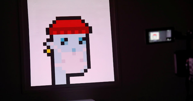 The non-fungible token (NFT) 'CryptoPunk #7523', a series of 10,000 unique pixel-art characters made by Larva Labs in 2017, was sold for $11.8m at Sotheby's earlier this year [File: Shannon Stapleton/Reuters]