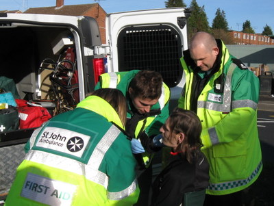 3 ambulance people around patient