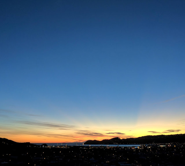 Sunset as seen from Miramar, out towards the airport, and over Lyall Bay