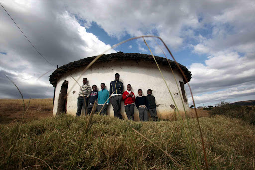 RIGHT TO EDUCATION: Children stand against the mud hut classroom at Mwezini Junior Secondary School Picture: FILE