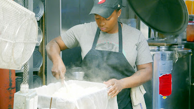 In the Kitchen with Chef Owner Troy MacLarty of Bollywood Theater - stirring the still hot paneer and mixing