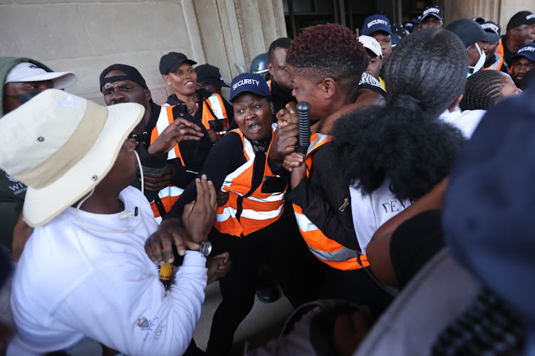 Security and protesting students clash at the entrance to the Great Hall at the University of the Witwatersrand in Johannesburg on March 2 2023.