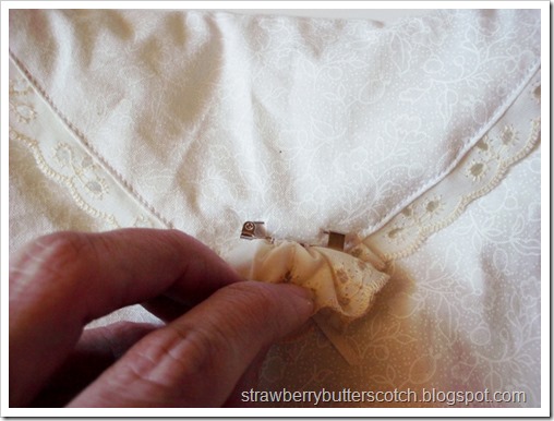 Close Up of Lace Rosette Pin on Off-white Purse