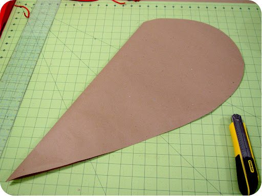 Fold a large piece of paper in half, draw half a heart, and cut out. This heart is about 26 inches tall.