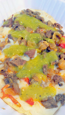 Las Adelas Mexican Comfort Food at Portland Mercado offering of Huarache de Cecina (an oval fried masa patty with salted beef and mushrooms, bell pepper, onion, cheese, and green or red salsa)