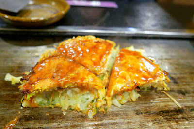 Dinner of okonomiyaki in Namba, Osaka at Ajinoya. This is the Hiroshima styled okonomiyaki which you can then top with as much additional sauce and bonito flakes as you want from containers on the table